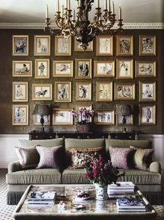 a living room filled with lots of furniture and pictures on the wall above it's coffee table