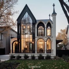 a large house with lots of windows on it's sides and an arched roof