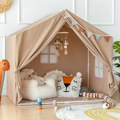 a child's play tent in the shape of a tiger with pillows and toys