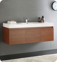 a bathroom vanity with two drawers and a clock on the wall next to it,