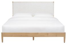 a bed with white linens and wooden headboard on top of it, in front of a white background