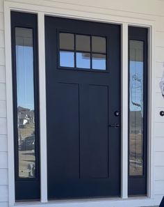 a black front door on a white house