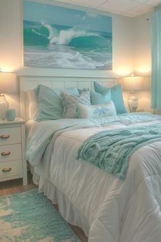 a white bed sitting under a painting on the wall next to a night stand with two lamps