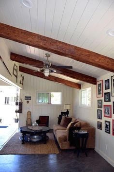 a living room filled with furniture and pictures on the wall