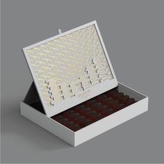 an open box of chocolates on a gray background