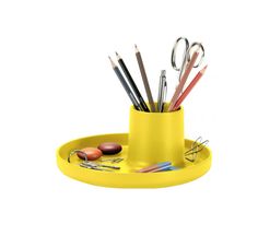 a yellow cup filled with pencils and scissors