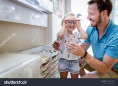 Health care, eyesight and vision concept. Little girl choosing glasses with father at optics store #Ad , #spon, #vision#concept#eyesight#Health Stock Photos, Health