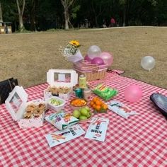 a picnic table covered with food and balloons