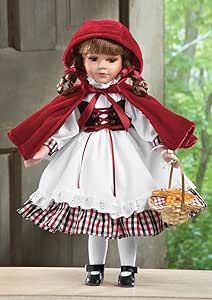 a doll dressed in red and white holding a basket