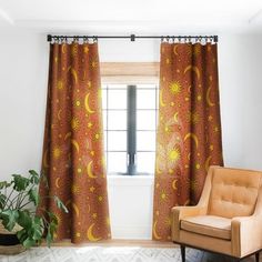 the sun and moon curtains are hanging in front of a window