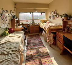 a bedroom with two twin beds and a rug on the floor