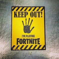 a yellow and black sign that says keep out i'm playing fortnite