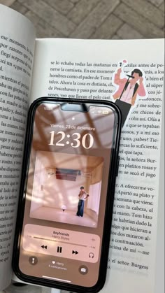 an open book with the image of a woman taking a photo on her cell phone