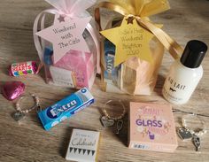 the contents of a personal care kit are laid out on a wooden table, including an empty bottle and keychain