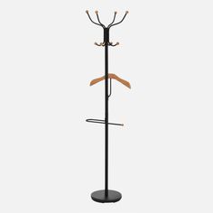 a coat rack with three coats and two umbrellas on the top, in front of a white background