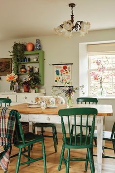 a dining room with green chairs and a wooden table