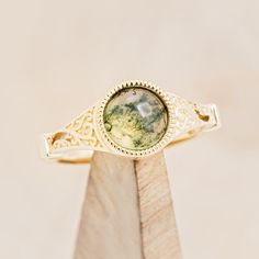 Product Details Ring Style: The "Selene" is an accented-style moss agate women's engagement ring. Many... Center Stone Engagement Ring, Green Agate Ring, Moss Agate Engagement Ring, Staghead Designs, Bezel Engagement Ring, Agate Engagement Ring, Moss Agate Ring, Detailed Ring, Unique Materials