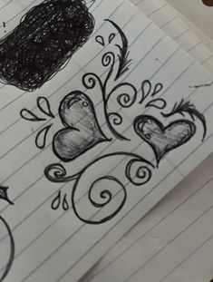 some drawings on lined paper with hearts and birds in the middle one is black and white