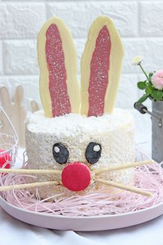 a cake decorated to look like a bunny with ears on it's head and tongue sticking out