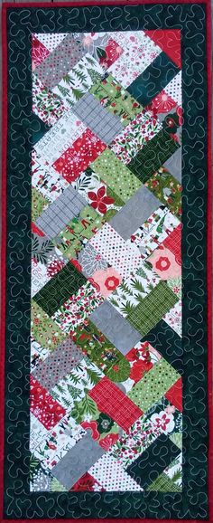 a red and green quilted wall hanging