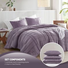 a bed with purple comforters and pillows on it