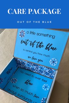 an open blue box with the words care package out of the blue on it and inside