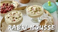 two desserts on a plate with spoons and utensils next to each other