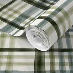 a green and white checkered wallpaper with a roll of paper