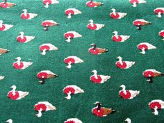 a green background with red and white ducks on it's sides, all over