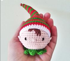 a hand holding a small crocheted christmas ornament