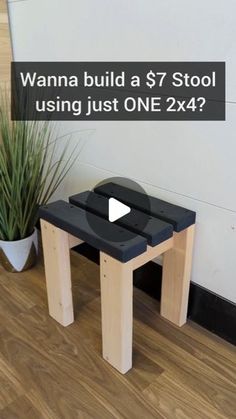 a small black table sitting next to a potted plant