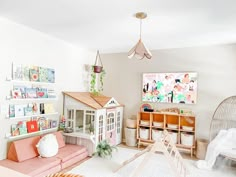 a living room filled with lots of furniture next to a wall mounted doll house on top of a wooden shelf