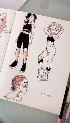 an open book with drawings of women in shorts and bras on top of it