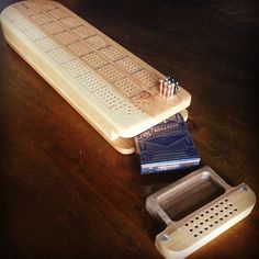 a toothbrush holder sitting on top of a wooden table next to a board with holes in it