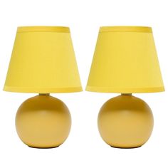 two yellow lamps sitting next to each other