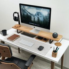 a computer monitor sitting on top of a white desk next to a keyboard and mouse