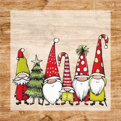 a group of gnomes standing next to each other on top of a wooden table