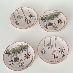 four plates with ornaments hanging from them