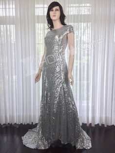 a mannequin wearing a silver sequin gown