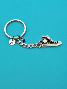 "This Black Sneaker Charm on Your Key Chain Will Remind You That Driving is Better Than Walking...Lol How to order: pick the style of your keychain from the drop-down menu. You may pick no personalization. You may add the initial disc. You may add a birthstone gem. You may add the initial disc and the birthstone gem.  Charm is made from zinc based alloy (lead and nickel safe).  Flat keyring is made of stainless steel and is 32mm outside diameter (1.26\"). Chain length: 1 1 /2 inches, it is 7mm w Charm Sneakers, Casual Customizable Shoe Charms For Gifts, Fun Black Shoe Charms For Gifts, Sneaker Key Chain, Shoe Keychains, Birthstone Gems, Light Amethyst, Size Comparison, Blue Zircon