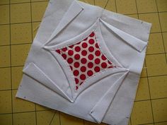 a piece of white fabric with red circles on it