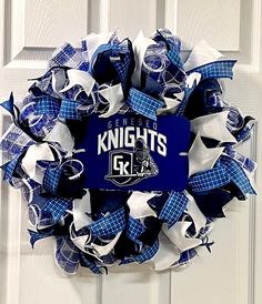 a blue and white wreath with the word knights on it in front of a door