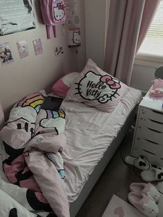 a bedroom with hello kitty bedding and pink curtains