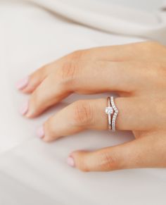 a woman's hand with a diamond ring on it