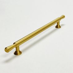 an antique brass pull handle on a white background