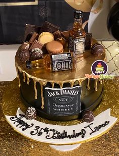 a birthday cake decorated with liquor and chocolates