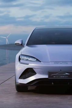 an electric car is parked near the water