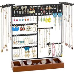 a jewelry rack with earrings and necklaces hanging from it's sides on a white background