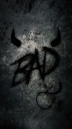 the word bad written in black ink on a concrete surface with two horns sticking out of it