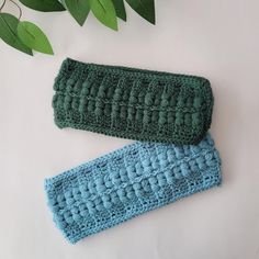 two crocheted headbands sitting next to each other